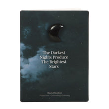 Load image into Gallery viewer, Darkest Nights Black Obsidian Crystal Moon Greeting Card.  Give the gift of magic with this meaningful crystal greeting card. Includes a small black obsidian crescent moon attached to a greeting card with &#39;The darkest nights produce the brightest stars’ text. Black obsidian is a spiritual stone used for protection, grounding, and creating a calming atmosphere.