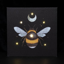 Load image into Gallery viewer, Forest Bee Light Up Canvas Plaque.  Add a touch of magic to your space with this 30x30cm light-up wall canvas. Features an ethereal forest bee illustration with embedded LED lights to create a mesmerizing glow.
