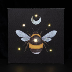 Forest Bee Light Up Canvas Plaque.  Add a touch of magic to your space with this 30x30cm light-up wall canvas. Features an ethereal forest bee illustration with embedded LED lights to create a mesmerizing glow.
